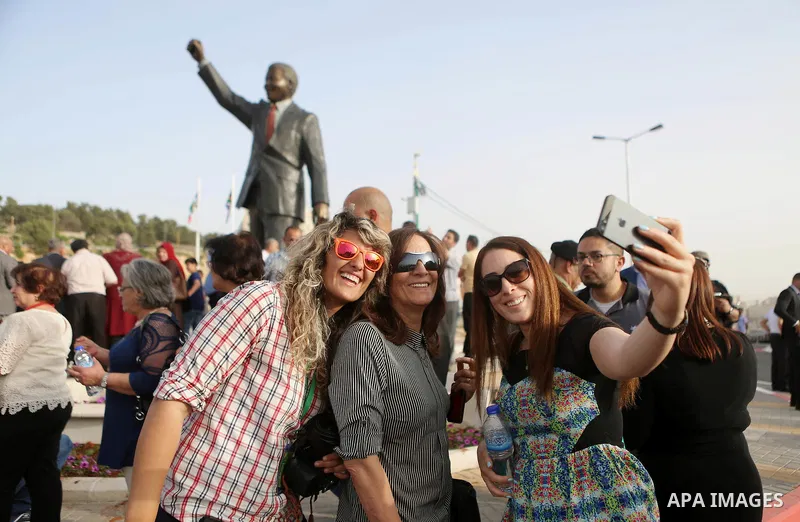 Palestinians take part in ceremony to unveil a sculpture of the first democratically elected South African president and anti apartheid leader Nelson Mandela, in the West Bank city of Ramallah, Tuesday, April 26, 2016. P...
