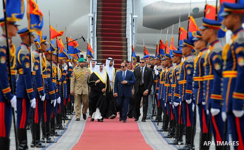A handout picture released by the Egyptian Presidency on April 26, 2016 shows Egyptian President Abdel Fattah al-Sisi and Bahrain's King Hamad bin Issa al-Khalifa reviewing the honor guard during a welcoming ceremony in...