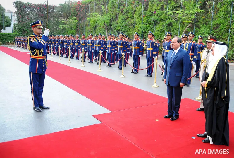 A handout picture released by the Egyptian Presidency on April 26, 2016 shows Egyptian President Abdel Fattah al-Sisi and Bahrain's King Hamad bin Issa al-Khalifa reviewing the honor guard during a welcoming ceremony in...
