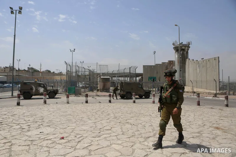 An Israeli security force stands guard at the Qalandia checkpoint, between Jerusalem and Ramallah in the Israeli occupied West Bank, after two Palestinians were shot as they approached security at the border carrying a k...