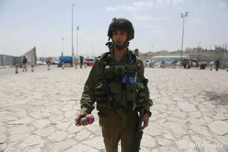 An Israeli security force stands guard at the Qalandia checkpoint, between Jerusalem and Ramallah in the Israeli occupied West Bank, after two Palestinians were shot as they approached security at the border carrying a k...