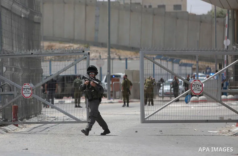 Israeli security forces stand guard at the Qalandia checkpoint, between Jerusalem and Ramallah in the Israeli occupied West Bank, after two Palestinians were shot as they approached security at the border carrying a knif...