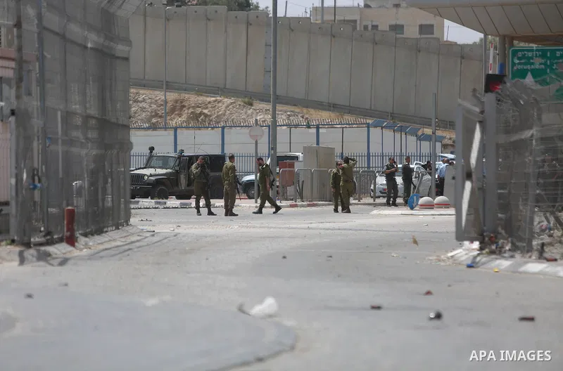 Israeli security forces stand guard at the Qalandia checkpoint, between Jerusalem and Ramallah in the Israeli occupied West Bank, after two Palestinians were shot as they approached security at the border carrying a knif...