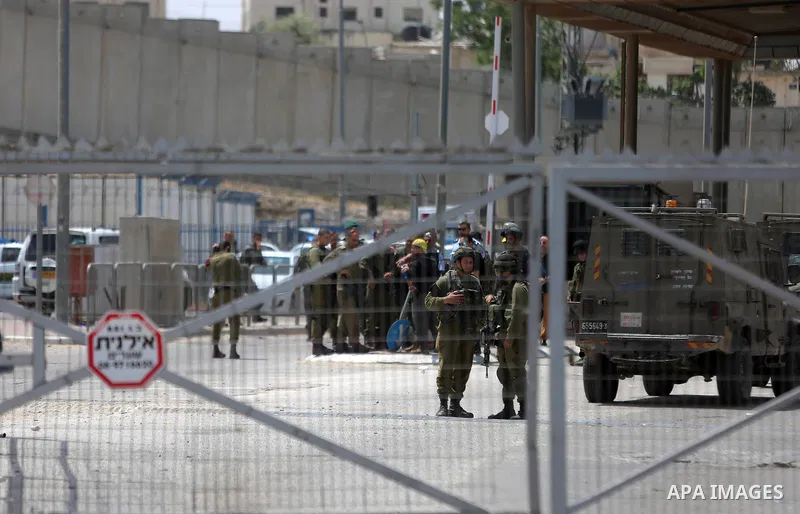 Israeli security forces stand guard at the Qalandia checkpoint, between Jerusalem and Ramallah in the Israeli occupied West Bank, after two Palestinians were shot as they approached security at the border carrying a knif...