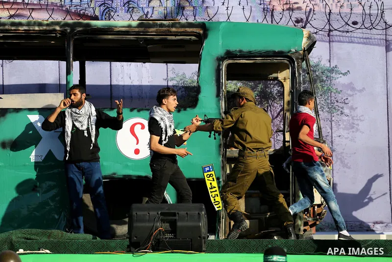A mock burnt Israeli bus is seen on a stage during an anti-Israel rally organised by the Palestinian Hamas movement in Gaza city April 28, 2016. Photo by Mohammed Asad
