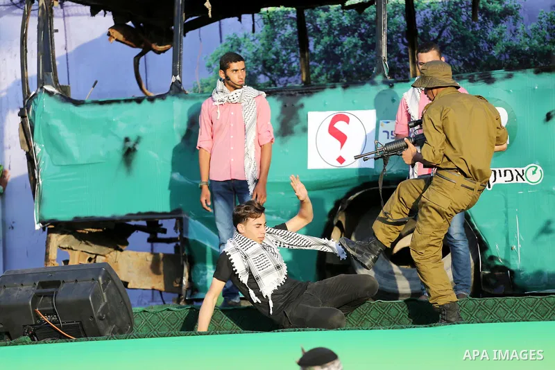 A mock burnt Israeli bus is seen on a stage during an anti-Israel rally organised by the Palestinian Hamas movement in Gaza city April 28, 2016. Photo by Mohammed Asad