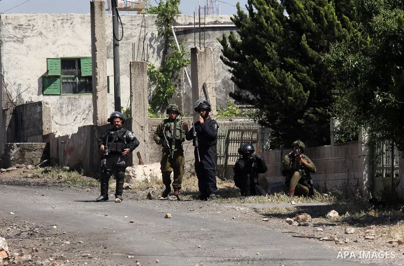 Israeli security forces aim at Palestinian protesters during clashes following a demonstration against the expropriation of Palestinian land by Israel on April 29, 2016 in the village of Kfar Qaddum, near Nablus, in the...