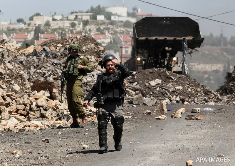 Israeli security forces aim at Palestinian protesters during clashes following a demonstration against the expropriation of Palestinian land by Israel on April 29, 2016 in the village of Kfar Qaddum, near Nablus, in the...