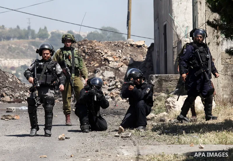 Israeli security forces aim at Palestinian protesters during clashes following a demonstration against the expropriation of Palestinian land by Israel on April 29, 2016 in the village of Kfar Qaddum, near Nablus, in the...