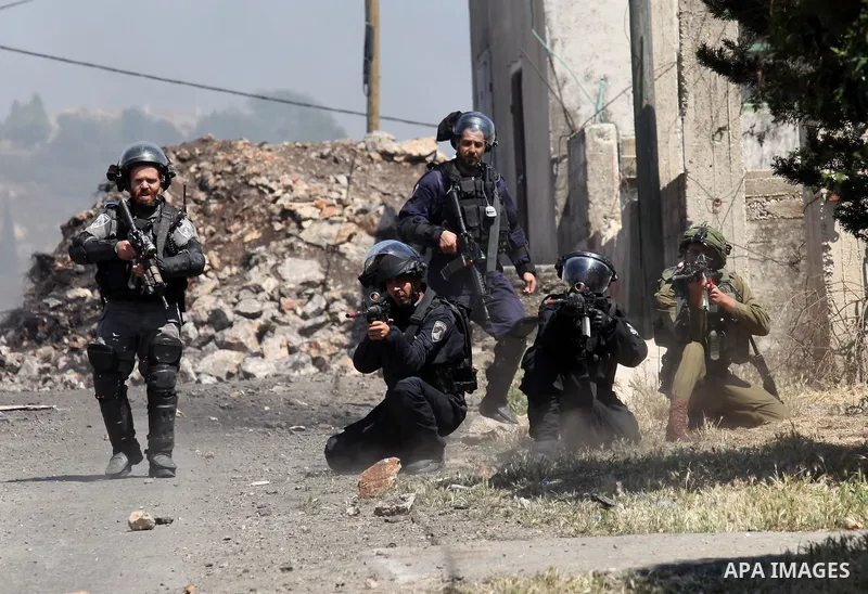 Israeli security forces aim at Palestinian protesters during clashes following a demonstration against the expropriation of Palestinian land by Israel on April 29, 2016 in the village of Kfar Qaddum, near Nablus, in the...