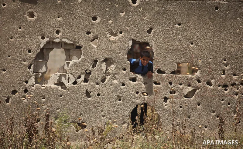 Palestinian boys play on the rubbles of houses, which were destroyed during the recent Israeli war 2014, in Shijaiyah neighborhood in the east of Gaza city, on April 30, 2016. Israel’s punitive ban on cement imports into...