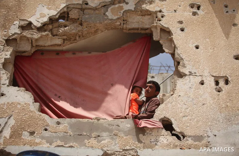 Palestinian boys play on the rubbles of houses, which were destroyed during the recent Israeli war 2014, in Shijaiyah neighborhood in the east of Gaza city, on April 30, 2016. Israel’s punitive ban on cement imports into...