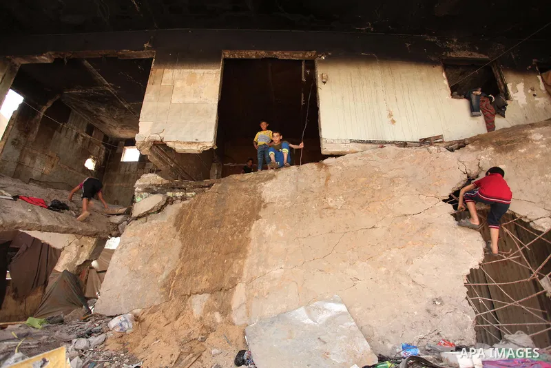Palestinian boys play on the rubbles of houses, which were destroyed during the recent Israeli war 2014, in Shijaiyah neighborhood in the east of Gaza city, on April 30, 2016. Israel’s punitive ban on cement imports into...
