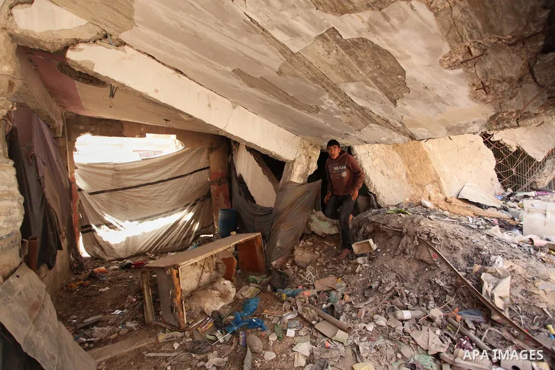 Palestinian boys play on the rubbles of houses, which were destroyed during the recent Israeli war 2014, in Shijaiyah neighborhood in the east of Gaza city, on April 30, 2016. Israel’s punitive ban on cement imports into...