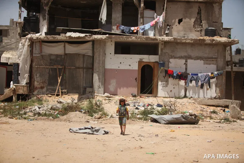 Palestinian boys play on the rubbles of houses, which were destroyed during the recent Israeli war 2014, in Shijaiyah neighborhood in the east of Gaza city, on April 30, 2016. Israel’s punitive ban on cement imports into...