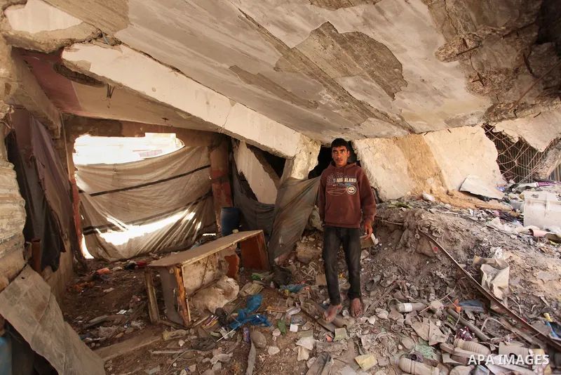 Palestinian boys play on the rubbles of houses, which were destroyed during the recent Israeli war 2014, in Shijaiyah neighborhood in the east of Gaza city, on April 30, 2016. Israel’s punitive ban on cement imports into...