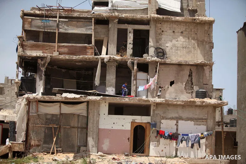 Palestinian boys play on the rubbles of houses, which were destroyed during the recent Israeli war 2014, in Shijaiyah neighborhood in the east of Gaza city, on April 30, 2016. Israel’s punitive ban on cement imports into...