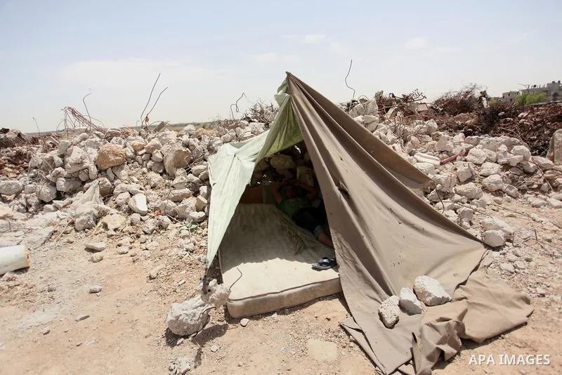 Palestinian boys play on the rubbles of houses, which were destroyed during the recent Israeli war 2014, in Shijaiyah neighborhood in the east of Gaza city, on April 30, 2016. Israel’s punitive ban on cement imports into...