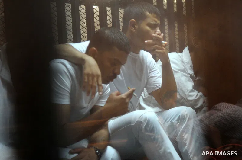 Egyptian defendants wait behind bars for the verdict in their retrial over a 2012 stadium riot in the canal city of Port Said at the police academy on the outskirts of the capital Cairo on April 30, 2016. Seven defendant...