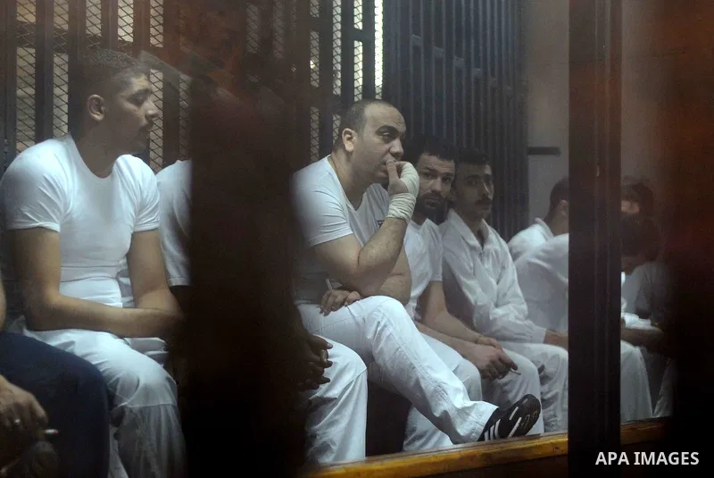 Egyptian defendants wait behind bars for the verdict in their retrial over a 2012 stadium riot in the canal city of Port Said at the police academy on the outskirts of the capital Cairo on April 30, 2016. Seven defendant...
