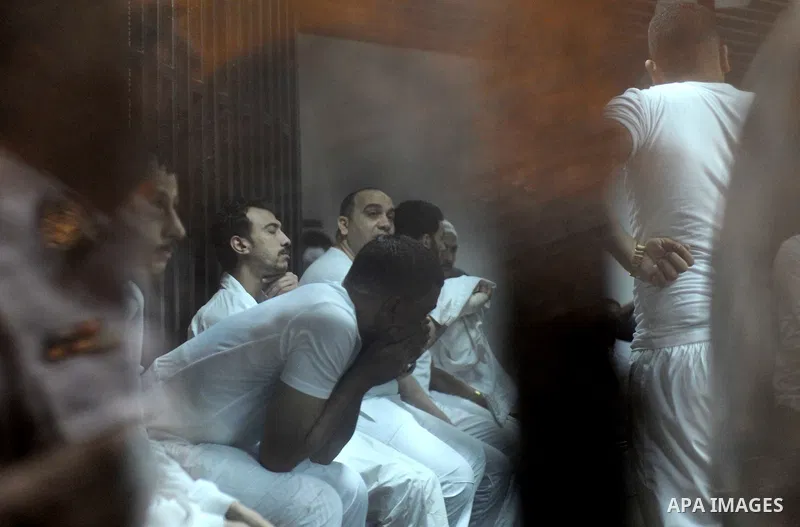 Egyptian defendants wait behind bars for the verdict in their retrial over a 2012 stadium riot in the canal city of Port Said at the police academy on the outskirts of the capital Cairo on April 30, 2016. Seven defendant...