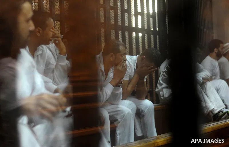 Egyptian defendants wait behind bars for the verdict in their retrial over a 2012 stadium riot in the canal city of Port Said at the police academy on the outskirts of the capital Cairo on April 30, 2016. Seven defendant...