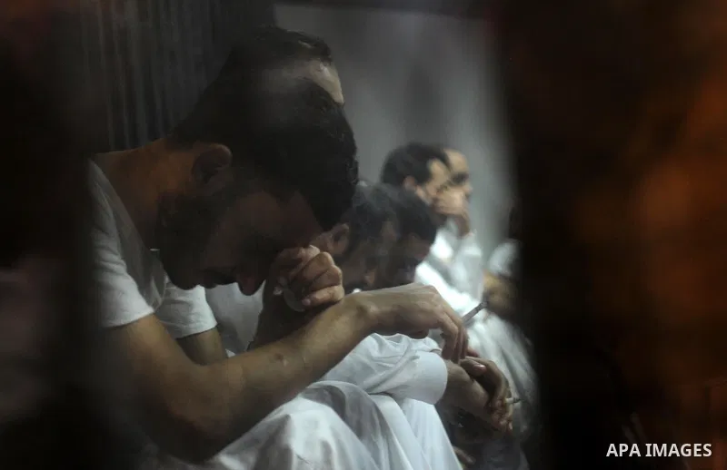 Egyptian defendants wait behind bars for the verdict in their retrial over a 2012 stadium riot in the canal city of Port Said at the police academy on the outskirts of the capital Cairo on April 30, 2016. Seven defendant...