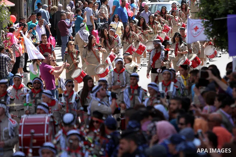 Palestinian christians march in the traditional Sabt al-Nour parade, in the West Bank city of Ramallah, on April 30, 2016. The Holy Fire is described by Orthodox Christians as a miracle that occurs every year at the Chur...