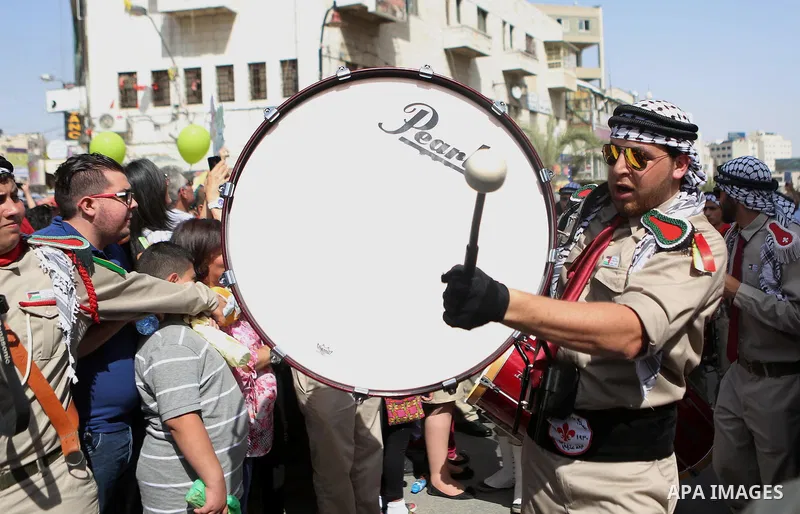 Palestinian christians march in the traditional Sabt al-Nour parade, in the West Bank city of Ramallah, on April 30, 2016. The Holy Fire is described by Orthodox Christians as a miracle that occurs every year at the Chur...