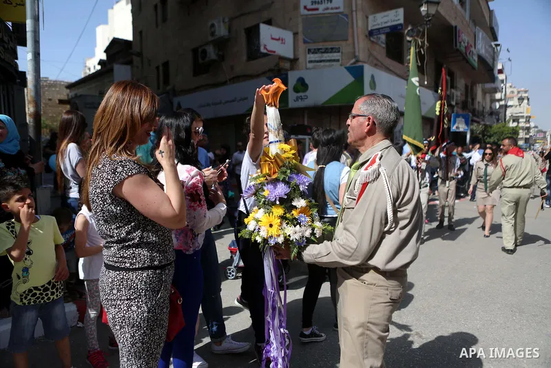 Palestinian christians march in the traditional Sabt al-Nour parade, in the West Bank city of Ramallah, on April 30, 2016. The Holy Fire is described by Orthodox Christians as a miracle that occurs every year at the Chur...