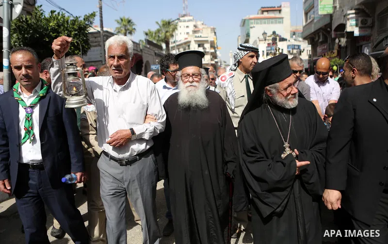 Palestinian christians march in the traditional Sabt al-Nour parade, in the West Bank city of Ramallah, on April 30, 2016. The Holy Fire is described by Orthodox Christians as a miracle that occurs every year at the Chur...