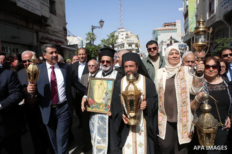 Palestinian christians march in the traditional Sabt al-Nour parade, in the West Bank city of Ramallah, on April 30, 2016. The Holy Fire is described by Orthodox Christians as a miracle that occurs every year at the Chur...