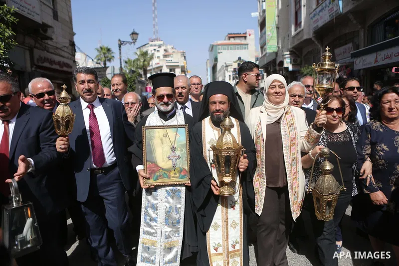 Palestinian christians march in the traditional Sabt al-Nour parade, in the West Bank city of Ramallah, on April 30, 2016. The Holy Fire is described by Orthodox Christians as a miracle that occurs every year at the Chur...