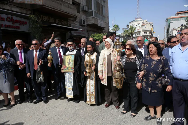 Palestinian christians march in the traditional Sabt al-Nour parade, in the West Bank city of Ramallah, on April 30, 2016. The Holy Fire is described by Orthodox Christians as a miracle that occurs every year at the Chur...