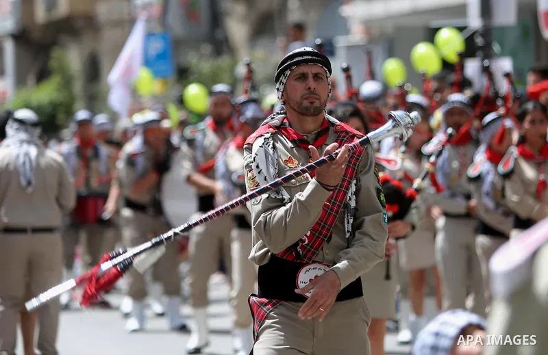 Palestinian christians march in the traditional Sabt al-Nour parade, in the West Bank city of Ramallah, on April 30, 2016. The Holy Fire is described by Orthodox Christians as a miracle that occurs every year at the Chur...