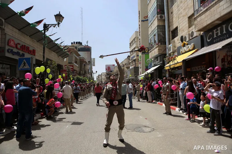 Palestinian christians march in the traditional Sabt al-Nour parade, in the West Bank city of Ramallah, on April 30, 2016. The Holy Fire is described by Orthodox Christians as a miracle that occurs every year at the Chur...