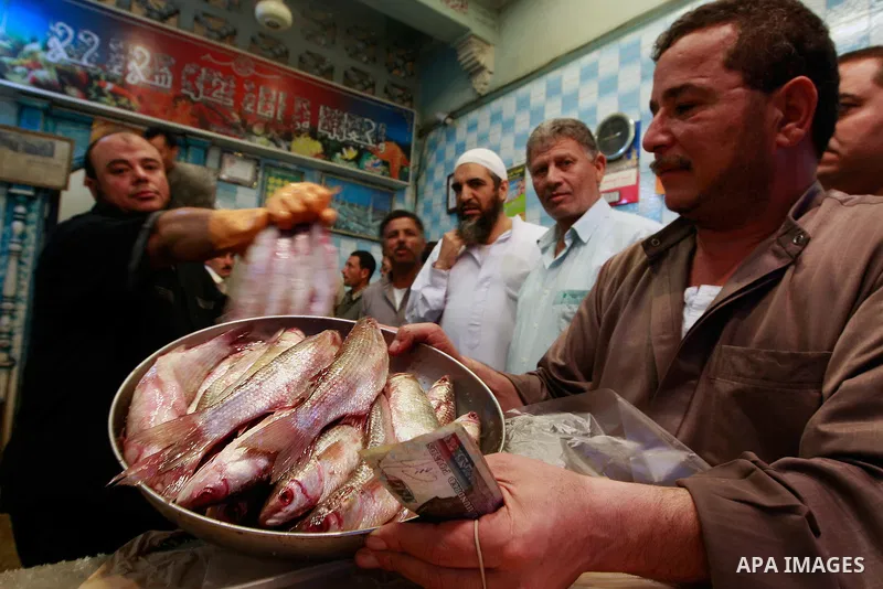 Egyptians buy the Herring or, salted fish during preparation for the upcoming the Sham El Nessim, or the Festival of Spring Breeze, which marks the beginning of spring, in Cair, on April 30, 2016. Photo by Amr Sayed