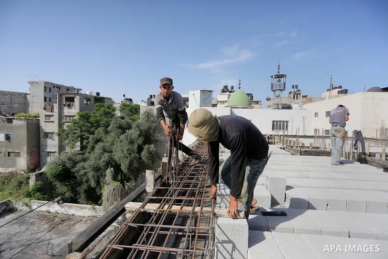 Palestinian construction workers built at a new house during the Workers' Day, in Gaza city, on May, 1, 2016. Photo by Mohammed Asad