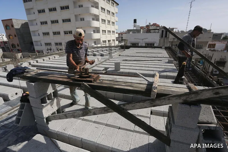 Palestinian construction workers built at a new house during the Workers' Day, in Gaza city, on May, 1, 2016. Photo by Mohammed Asad