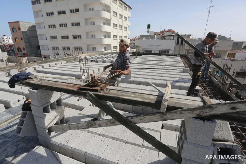 Palestinian construction workers built at a new house during the Workers' Day, in Gaza city, on May, 1, 2016. Photo by Mohammed Asad