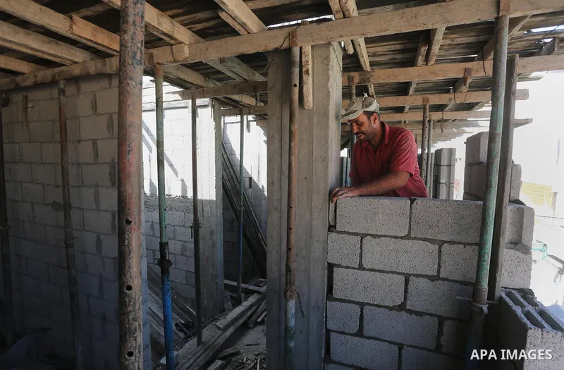 Palestinian construction workers built at a new house during the Workers' Day, in Gaza city, on May, 1, 2016. Photo by Mohammed Asad