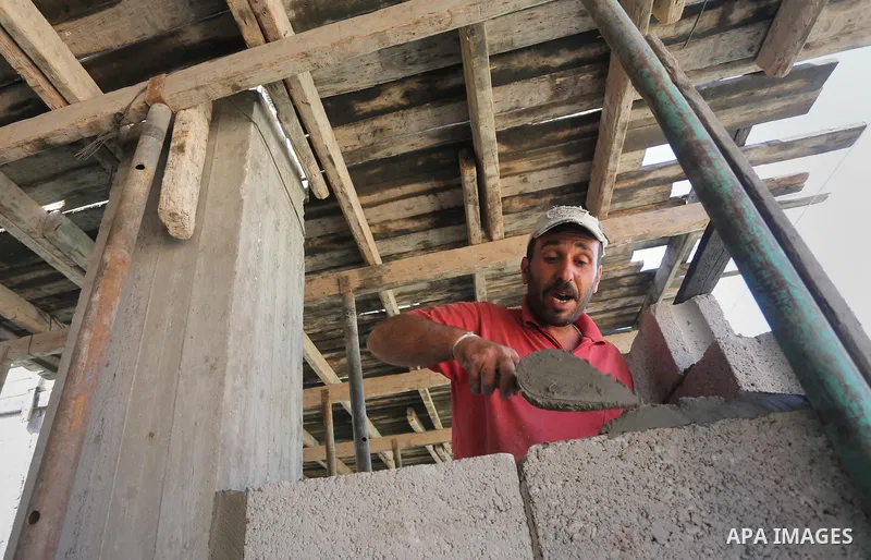 Palestinian construction workers built at a new house during the Workers' Day, in Gaza city, on May, 1, 2016. Photo by Mohammed Asad