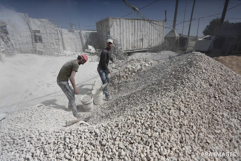 Palestinian workers crush stones and cement blocks from houses destroyed by Israeli shelling during the 50-day Israeli war in the summer of 2014, during the Workers' Day, in Gaza city, on May, 1, 2016. Photo by Mohammed...