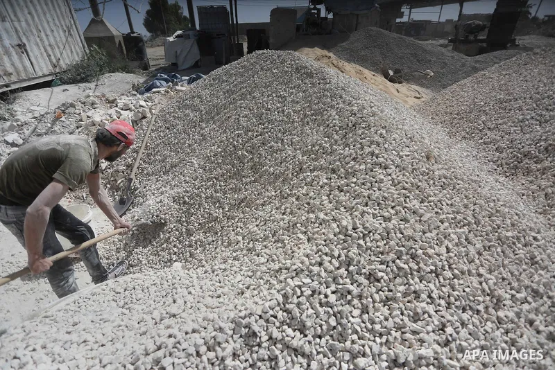 Palestinian workers crush stones and cement blocks from houses destroyed by Israeli shelling during the 50-day Israeli war in the summer of 2014, during the Workers' Day, in Gaza city, on May, 1, 2016. Photo by Mohammed...