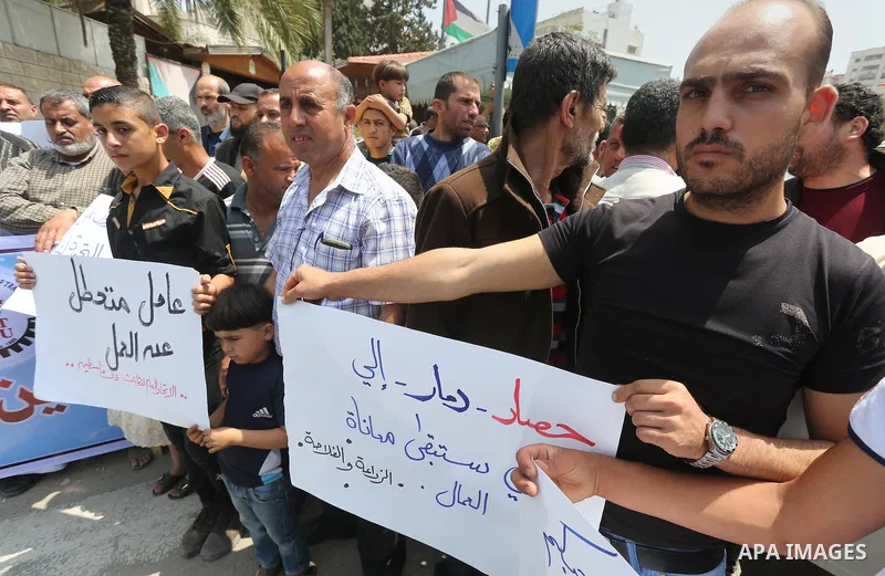 Palestinian workers demonstrate against the Israeli blockade of the Gaza Strip during a rally marking May Day, on May 1, 2016, in Gaza City. Israel has maintained a blockade of Gaza since 2006, and recently banned the su...