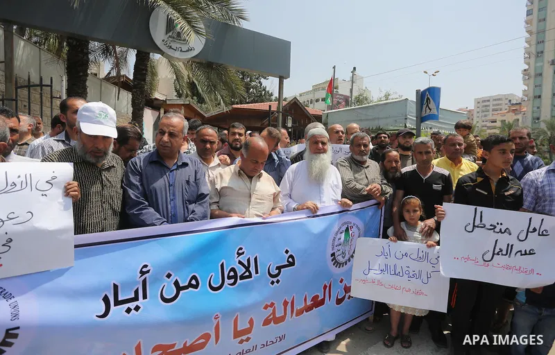 Palestinian workers demonstrate against the Israeli blockade of the Gaza Strip during a rally marking May Day, on May 1, 2016, in Gaza City. Israel has maintained a blockade of Gaza since 2006, and recently banned the su...