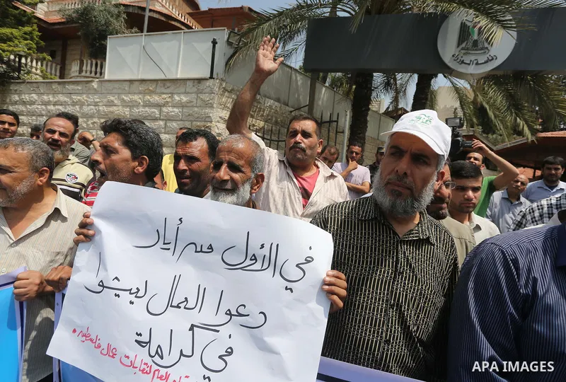 Palestinian workers demonstrate against the Israeli blockade of the Gaza Strip during a rally marking May Day, on May 1, 2016, in Gaza City. Israel has maintained a blockade of Gaza since 2006, and recently banned the su...