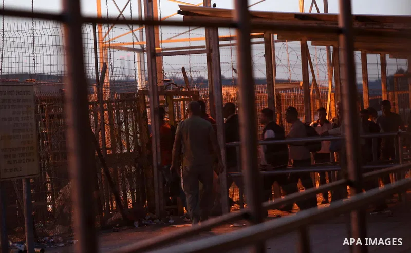 Palestinian labourers working in Israel wait to cross a checkpoint to go to work through the main Israeli terminal near the West Bank town of Qalqilya on International Workers' Day May 1, 2016. Photo by Stringer