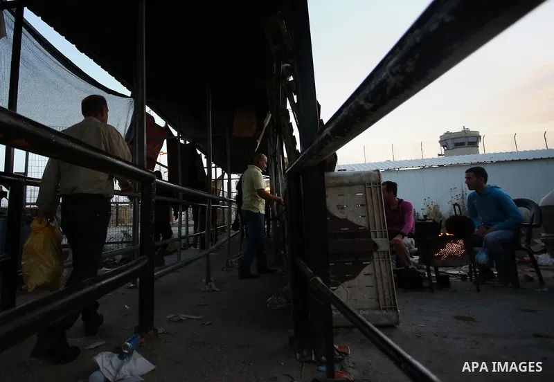 Palestinian labourers working in Israel wait to cross a checkpoint to go to work through the main Israeli terminal near the West Bank town of Qalqilya on International Workers' Day May 1, 2016. Photo by Stringer