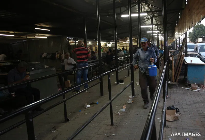 Palestinian labourers working in Israel wait to cross a checkpoint to go to work through the main Israeli terminal near the West Bank town of Qalqilya on International Workers' Day May 1, 2016. Photo by Stringer